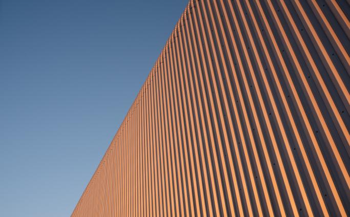 Tinplate and metal architectural wall of the building against the sky