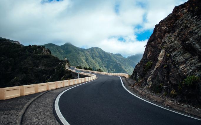 Winding road leading to mountains