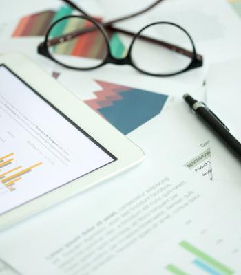 ipad charts with glasses and pen